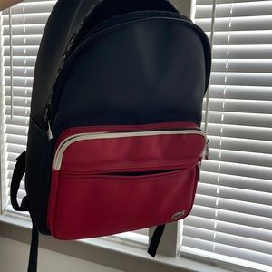 BLACK RED LACOSTE BACKPACK GENTLY USED STAIN IN FRONT